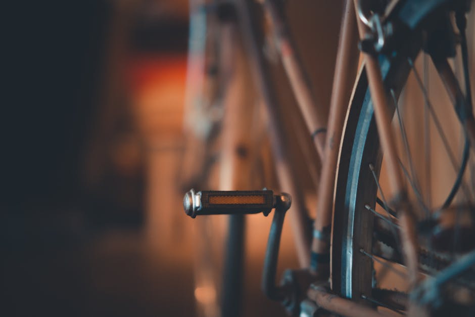 A detailed close-up of a vintage bicycle pedal with a soft focus background.