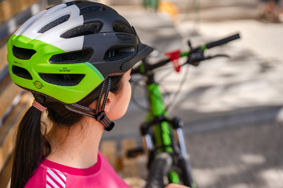 Female cyclist wearing a protective helmet prepares for outdoor biking adventure.